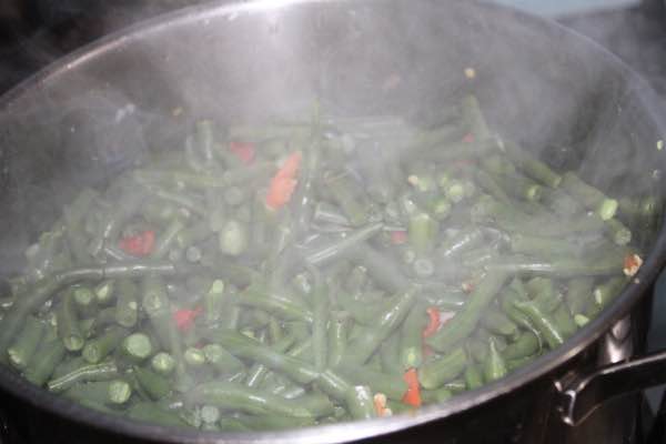 Boil the green beans before adding the curry powder