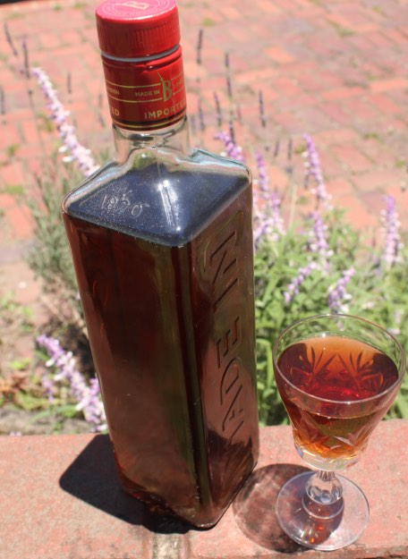 Cherry guava mead in a bottle and glass Cherry guava mead in a bottle and glass