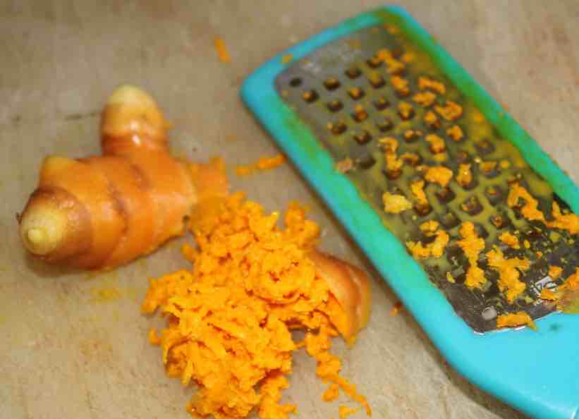 Freshly grated turmeric root. Freshly grated turmeric root.