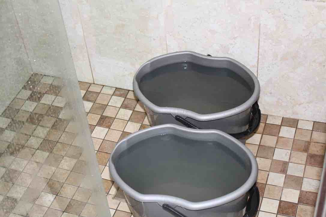 Harvesting shower water.