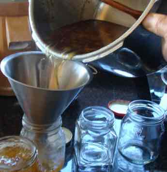 Lime marmalade being poured into jars. Lime marmalade being poured into jars.