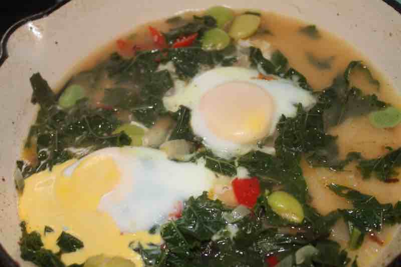 Poached eggs in pan.