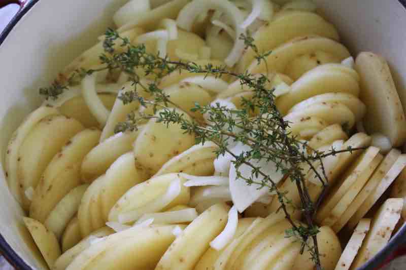 Sliced new potatoes with thyme. Sliced new potatoes with thyme.