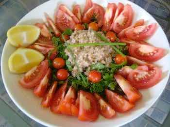 Tabbouleh salad made with tomato, lemon juice and bulgar. Tabbouleh salad made with tomato, lemon juice and bulgar.