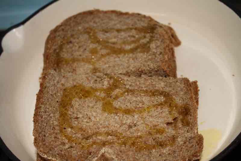 Toasted egg sandwich drizzled with olive-oil. Toasted egg sandwich drizzled with olive-oil.