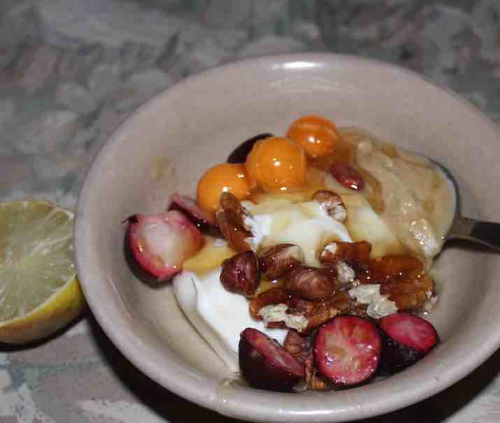 Fruit and nut breakfast with honey and yoghurt. Fruit and nut breakfast with honey and yoghurt.