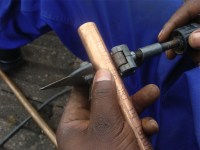 Solar tubes fitting 2 shows cutting the copper pipe for your passive solar water heater.